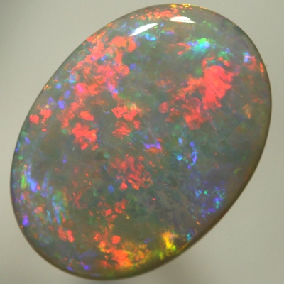 SOLID SEMI BLACK OPAL Large opal, red to blue to greens with a hint of gold. SEE VIDEO
